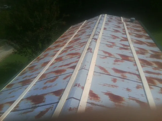 Rusted metal roof panels with new wood purlins before replacement — Storm Damage Roof Repair in Mcdaniel by Roofing Brothers